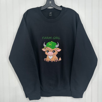 embroidered highland cow with green hat that says farm girl on a black sweatshirt