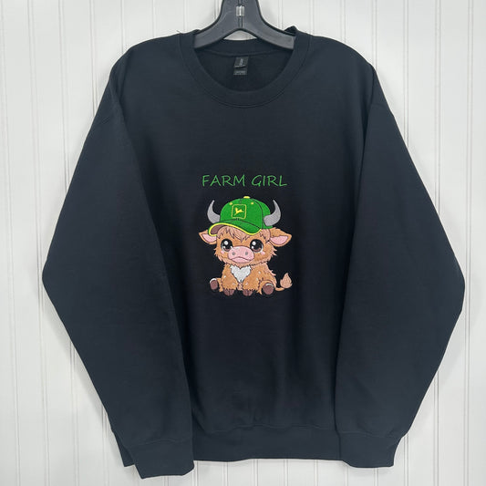 embroidered highland cow with green hat that says farm girl on a black sweatshirt