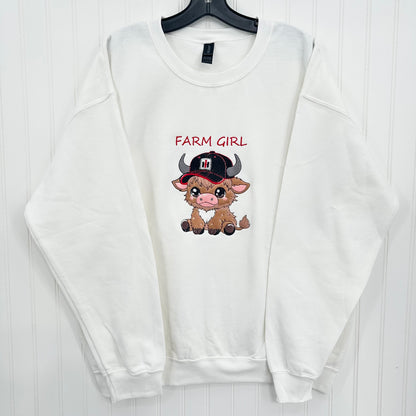 embroidered highland cow wearing a tractor hat on a white sweatshirt and says farm girl