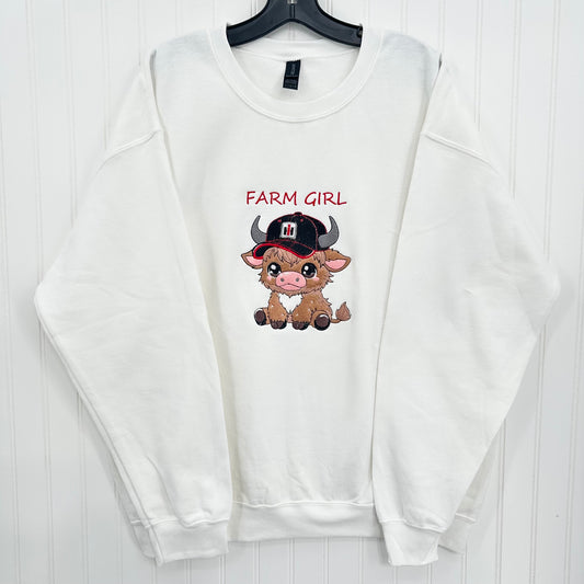 embroidered highland cow wearing a tractor hat on a white sweatshirt and says farm girl