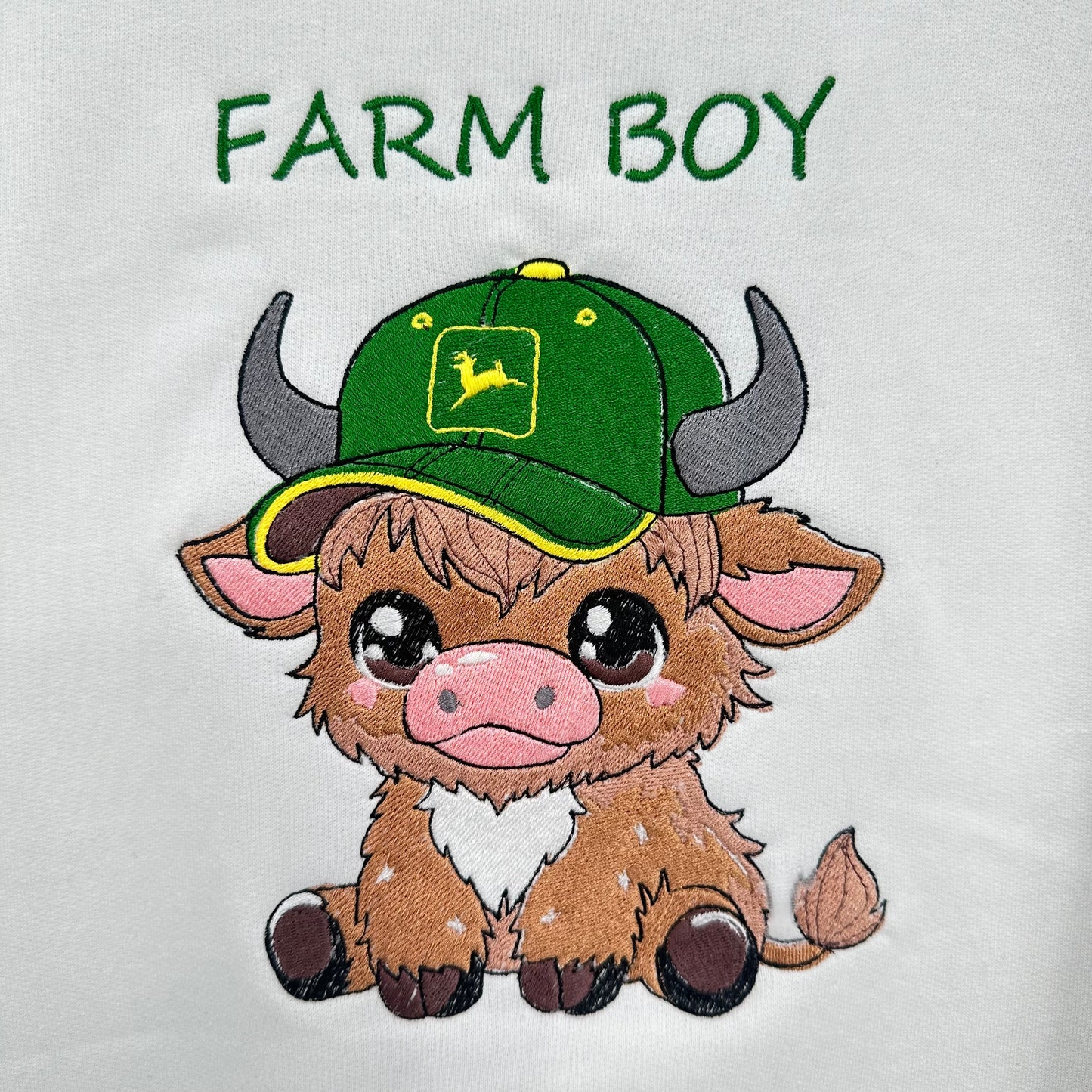 highland cow embroidered wearing a green tractor hat