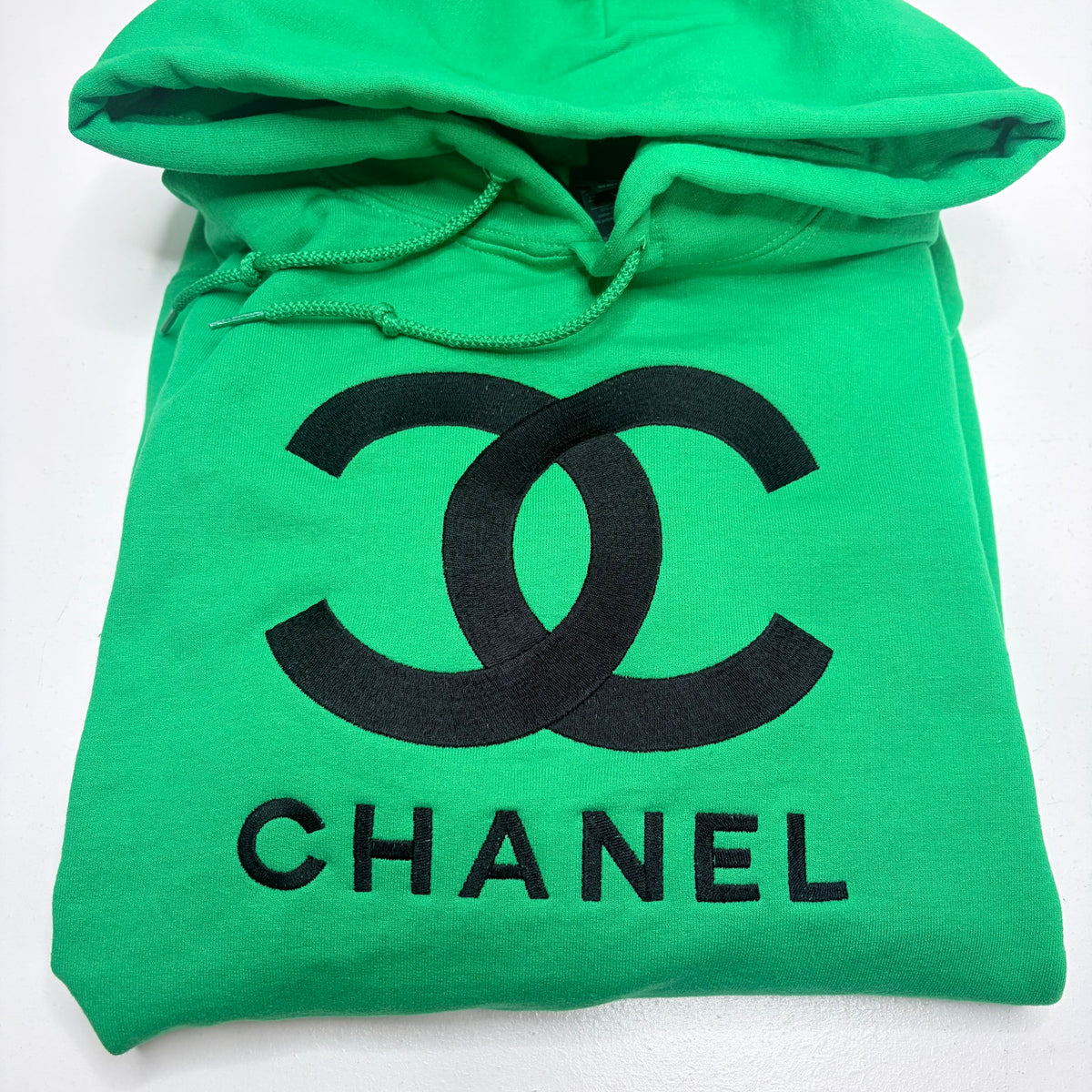 green hooded sweatshirt with chanel logo embroidered in black