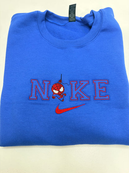 Blue sweatshirt with a red and black design and Nike logo on a beige background