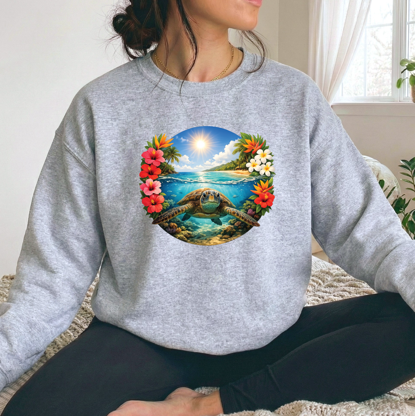 woman wearing a gray sweatshirt with a sea turtle underwater in the ocean with tropical flowers graphic